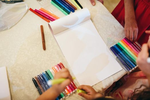Children drawing with markers and having fun