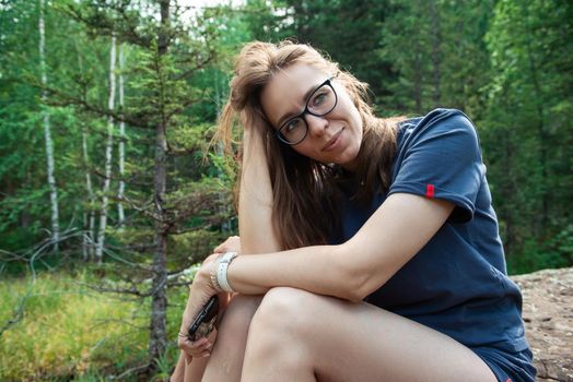 Healthy lifestyle woman walking and restiing in summer forest area