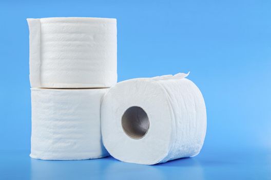 Tissue paper rolls on blue background.
