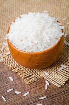 Organic Thai Jasmine rice grain in wooden bowl preparing for cooked