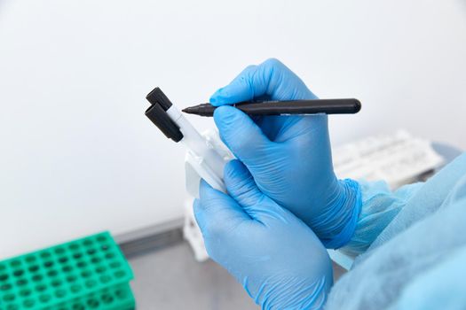 Scientist working with blood sample in laboratory. High quality photo