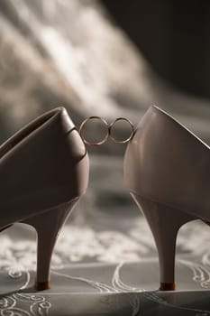 Bride's engagement ring on wedding day with beautiful holiday shoes