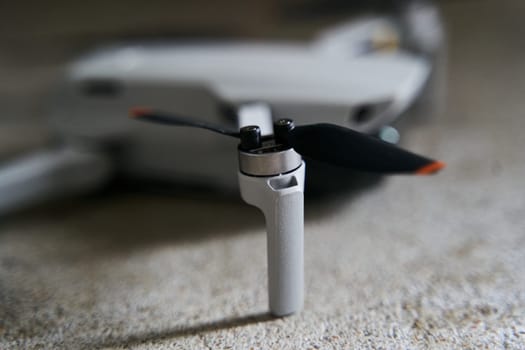 Small gray quadcopter on a gray background. Quadrocopter close-up. High quality photo