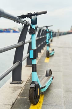 Electric scooters for rent, docked on the embankment. High-quality photo