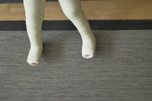 little child boy with plaster bandage on leg