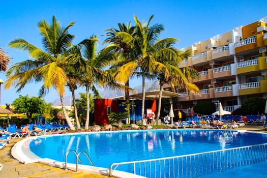 Swimming pool, open-air restaurant and exotic trees of luxury hotel, Tenerife island, Spain. High quality photo