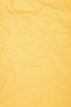 Vertical yellow color creased paper background texture.