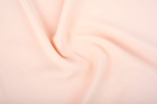 Texture of the satin fabric of beige color for the background