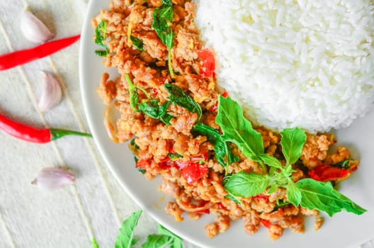 Thai street food, basil fried rice, minced pork and rice on tablecloth.