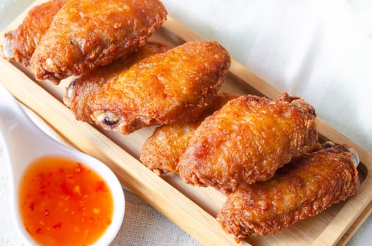 Close up of Fried chicken wings and sauce chili Thai street food.