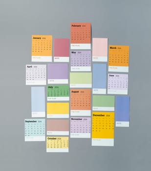 Calendar sheets with year 2024 and paper note on grey color background.
