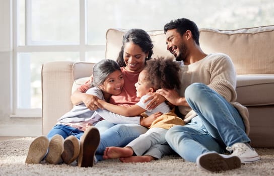 Love, home and family on the floor, smile and bonding with affection, peaceful and loving together. Parents, mother or father with female children, kids or girl on the ground, lounge or weekend break.
