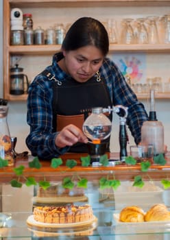 barista man lighting a japanese coffee pot with fire inside a coffee shop. High quality photo