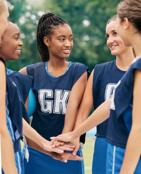 Support, teamwork and sports with netball women for motivation, planning and training on field. Happy, vision and goals with diversity of friends hands in outdoor park for games, summer and workout.