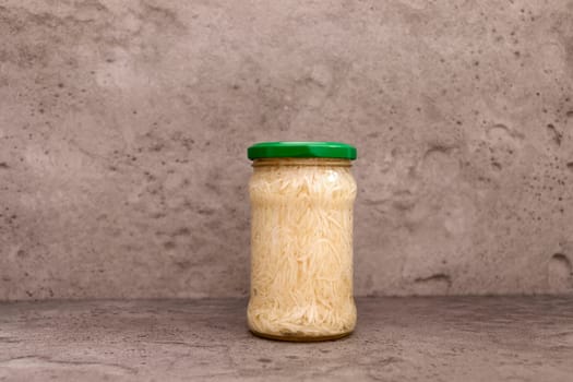 Preserved Celery Root Salad In Glass Jar With Screw Metal Cap On Shelf. Apium Graveolens, Shredded And Pickled Celery Crops, Tuber. Culinary. Vitamins C, K, A, E, PP, B. Copy Space, Horizontal Plane.
