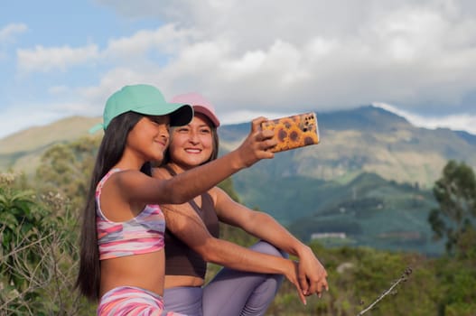 mom and daughter taking a selfie with a cell phone on a sunny day on vacation. High quality photo