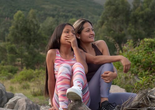 happy family enjoying nature. happy mom and daughter outdoors in sportswear. High quality photo
