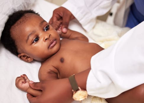 African, little baby and bed for health checkup with doctor or paediatrician with infant or healthcare clinic and medical wellness. Child patient, consulting and expert with toddler in the hospital.