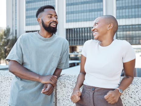 Conversation, black people and happy couple of friends in a city with happiness outdoor. Urban lifestyle, laughing woman and communication by a building with partner and smile from discussion.