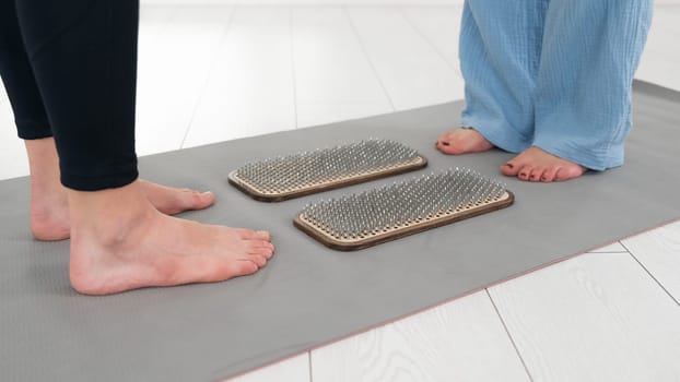 Female feet next to sadhu boards in yoga studio