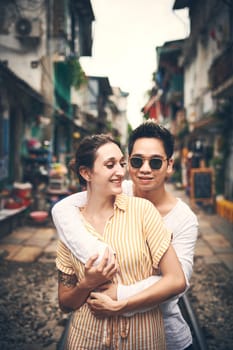 My love makes the best travel partner. a young couple sharing a romantic moment in the city of Vietnam