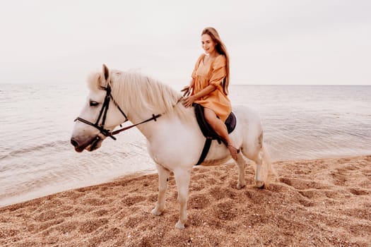 A white horse and a woman in a dress stand on a beach, with the sky and sea creating a picturesque backdrop for the scene