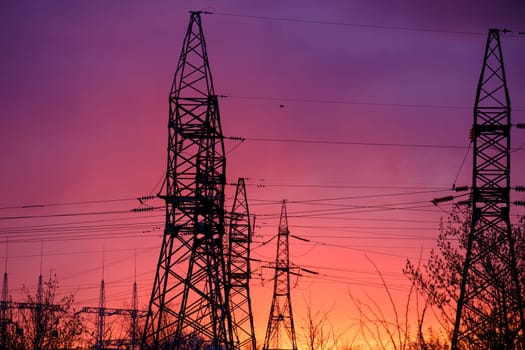 View of high voltage pole power transmission tower on sunset. Panorama high voltage tower with power lines. Download high quality photo