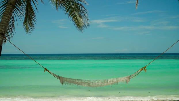 Seascape: beautiful tropical beach with hammock. Panglao, Philippines. Summer and travel vacation concept.