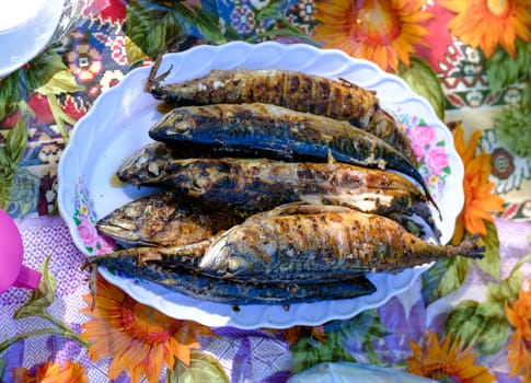 grilled spicy mackerel fish on a dish. top view. grilled fish on the grill