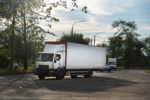 Delivery van in the city. truck on the road. white van in motion on the road. delivery truck