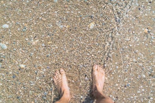 man walking barefoot in the sand in summer holidays on beach. High quality photo