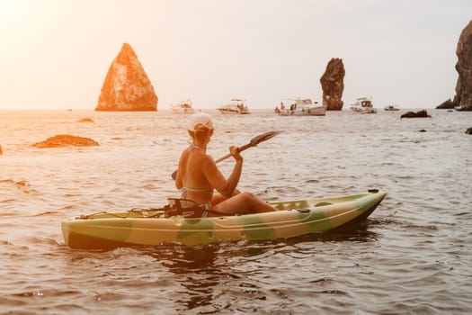 Kayaking. Travel adventure kayak on the tropical sea on a sunny day. Woman rowing a canoe.