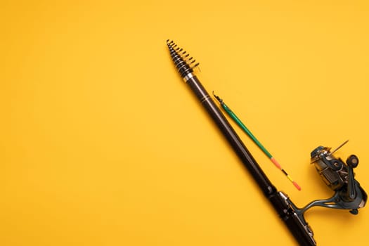 Design Fishing Spinning Rod, Reel on Yellow Background. Hobby, Leisure. Mockup, Copy Space for Text. Horizontal Plane. High quality photo