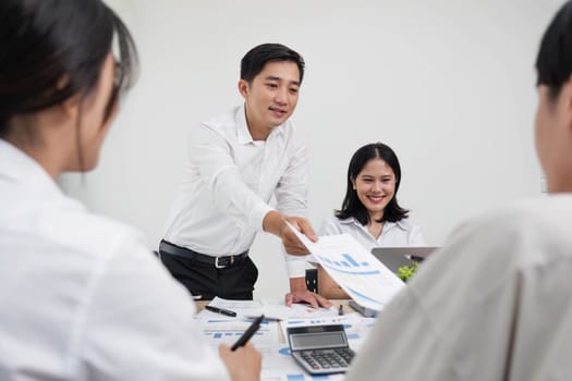 Group of creative asian business meeting and discussing strategy startup project analysis finance .Success asian business people work plan and brainstorm marketing idea with laptop in office.Teamwork..