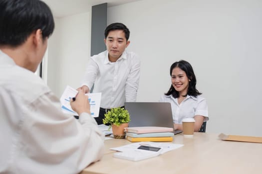 Group of creative asian business meeting and discussing strategy startup project analysis finance .Success asian business people work plan and brainstorm marketing idea with laptop in office.Teamwork..