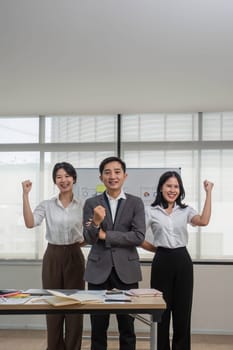 Portrait of smiling group Asian professional confident business people team standing and looking at camera..