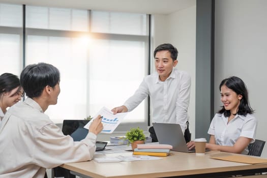 Group of creative asian business meeting and discussing strategy startup project analysis finance .Success asian business people work plan and brainstorm marketing idea with laptop in office.Teamwork..