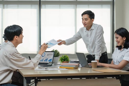 Group of creative asian business meeting and discussing strategy startup project analysis finance .Success asian business people work plan and brainstorm marketing idea with laptop in office.Teamwork..