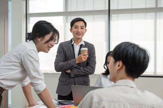 Group of creative asian business meeting and discussing strategy startup project analysis finance .Success asian business people work plan and brainstorm marketing idea with laptop in office.Teamwork..