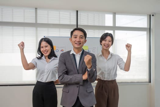 Portrait of smiling group Asian professional confident business people team standing and looking at camera..