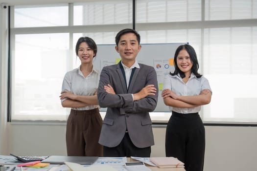 Portrait of smiling group Asian professional confident business people team standing and looking at camera..