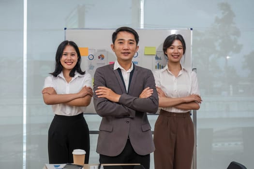 Portrait of smiling group Asian professional confident business people team standing and looking at camera..