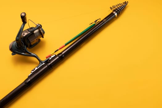 Mockup Fishing Spinning Rod, Reel on Yellow Background. Hobby, Leisure. Copy Space for Text On Right. Horizontal Plane. High quality photo