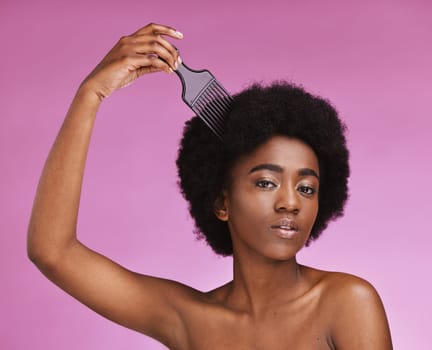 Portrait, hairstyle or afro brush on beauty studio background in relax grooming routine, texture maintenance or growth wellness. Black woman, comb or natural hair and skincare makeup on isolated pink.