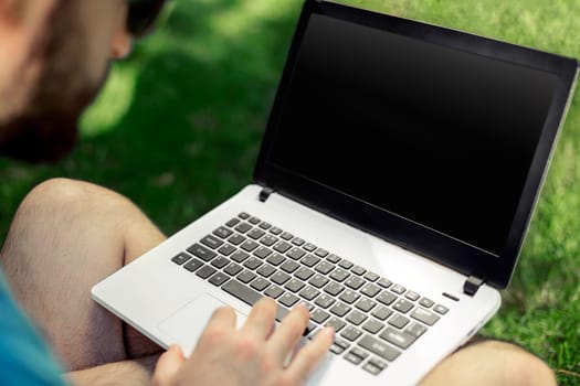 Top view male hands using notebook outdoors in urban setting while typing on keyboard, businessman freelancer working on computer while sitting on city park bench, tourist working on laptop, filter