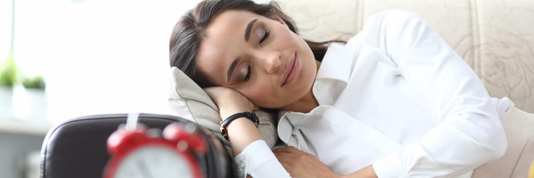 Beautiful young woman sleeps serenely on couch. Daytime nap rest and break