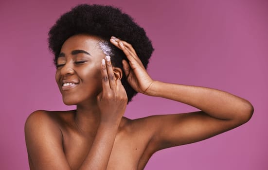 Happy black woman, hands or afro haircare product on beauty background in grooming, growth texture or roots wellness. Conditioner, cream or natural hair model with skincare on isolated pink backdrop.