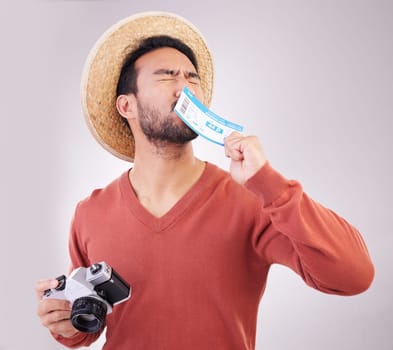 Excited man, ticket and visa with camera, travel and paperwork for holiday adventure and on white background. Smile, travel and happy person kissing boarding pass for vacation, journey and happiness