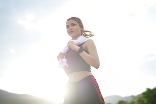 Young attractive beautiful athletic runner woman runs in the green park jogging. Healthy and active lifestyle concept.