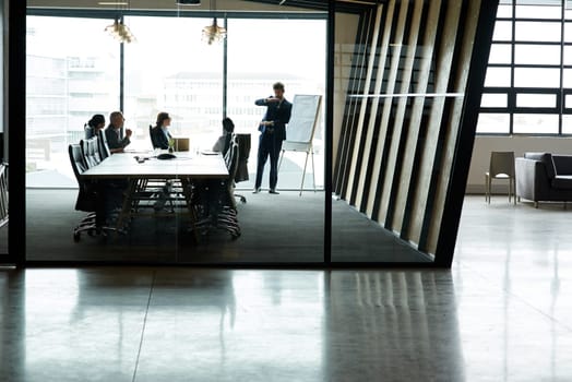 Shot of a group of executives having a meeting in a boardroom.